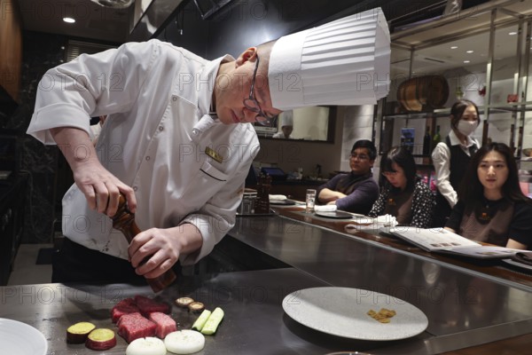 Chef prepares Kobe steak and guests watch in amazement at the Kobe Plaisir restaurant, Kobe, Hyogo,