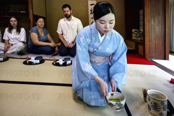 Tea master during a tea ceremony with guests, serving traditional green tea, Kyoto, Higashiyama,