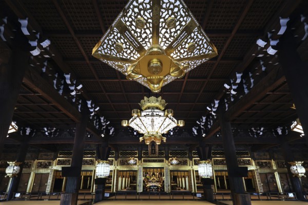 Interior view of Nishi Hongan-ji Temple with impressive chandelier and ornate woodwork, Kyoto,