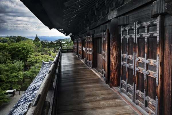 Sanmon wooden main gate of Nanzen-ji Temple in Kyoto with lush nature in the background, Kyoto,