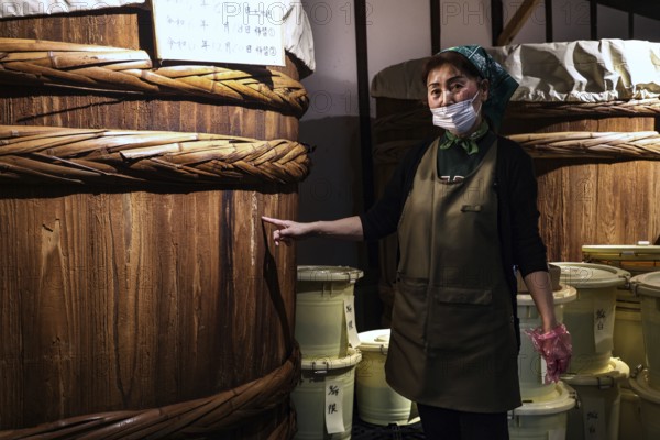 A woman explains how to make miso at the Ishii Miso Brewery in Matsumoto, Matsumoto, Japan