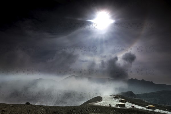 Intense sunlight and fog over the crater and bunker at Nakadake, Aso, Aso, Kyushu, Japan