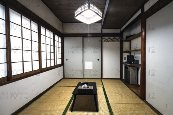 Minimalist Japanese room with tatami floor and sliding walls, Beppu, Oita, Japan