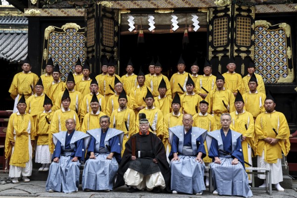Ceremonial group photo of Shinto priests wearing traditional dress in front of Toshogu Shrine,