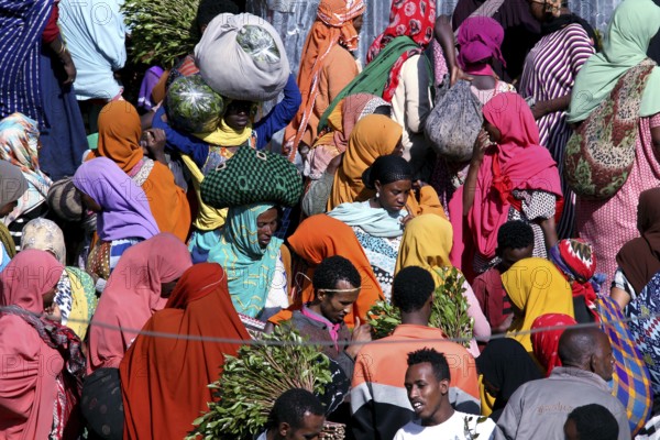 Crowds of people wearing colorful robes at a market, Awaday, Ethiopia
