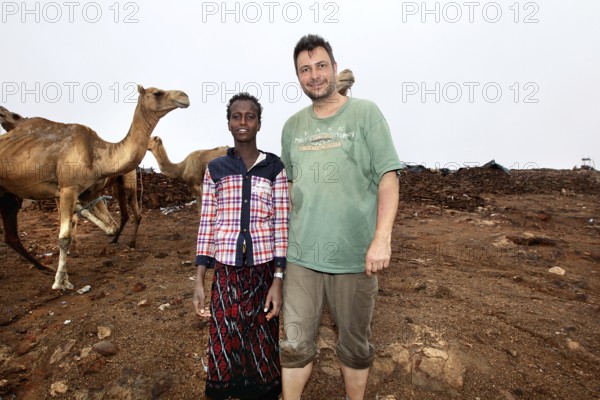 A camel driver with Roland's company and camels at Erta Ale Camp, Erta Ale, Ethiopia