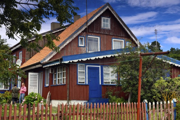 Traditional Lithuanian wooden house with colorful exterior and garden, Nida, Curonian Spit,