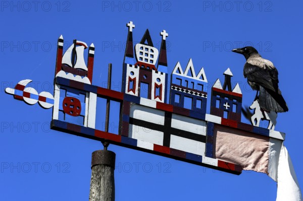 Colourful Kuren pennant with a bird on a bright sky, symbolism of the Curonian Spit, Nida, Curonian