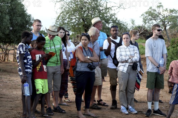 Group of tourists observes the Hamer initiation ritual with interest and curiosity, Turmi, null,