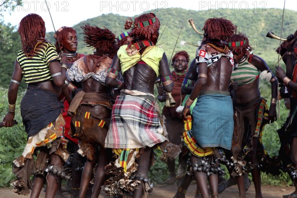 Hamer woman, wearing traditional clothes, dancing in circles, part of an initiation ritual, Turmi,
