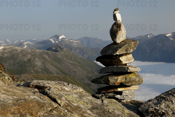 Stone pyramid on a mountain with a wide view over mountain ranges, Geirangerfjord, Dalsnibba,