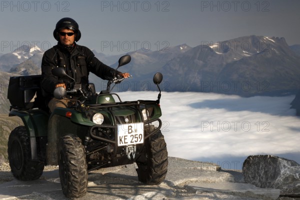 Person on ATV enjoying breathtaking views of Dalsnibba in Geirangerfjord, Dalsnibba,