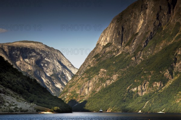 Majestic panorama of Nærøyfjord near Gudvangen with high mountains and still water, Gudvangen,