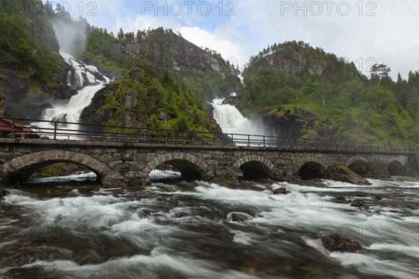 Summer day visiting Låtefossen falls near Odda, flowing water and green valley, Vestland, Norway