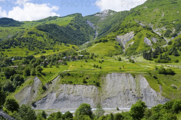 View of deep valleys and green hills in a mountainous and wooded region, landscape between Kvesheti
