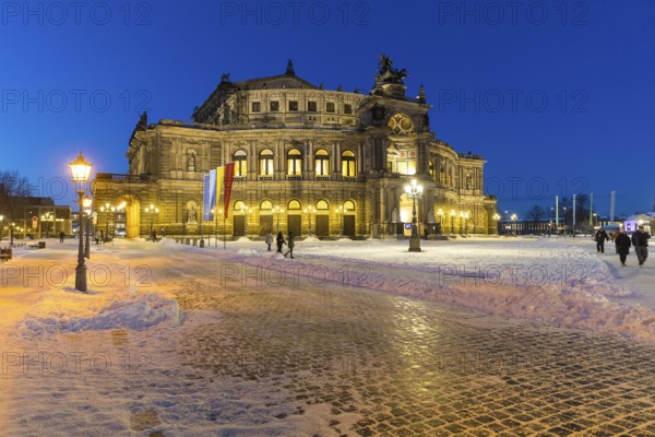 Illuminated Semper Opera House and Theatre Square with snow at dusk, Old Town of Dresden, Saxony,