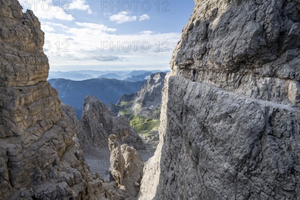 View from the Bocca degli Armi gap, mountaineers on a rock band on the Via Ferrata Bocciere
