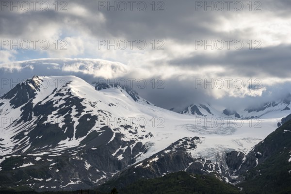 Mountain peak with Worthington Glacier glacier, dramatic cloudy sky, picturesque landscape on