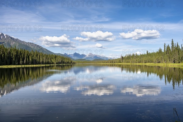 Mountains are reflected in idyllic Crystal Lake, McCarthy Highway, Wrangell St. Elias National