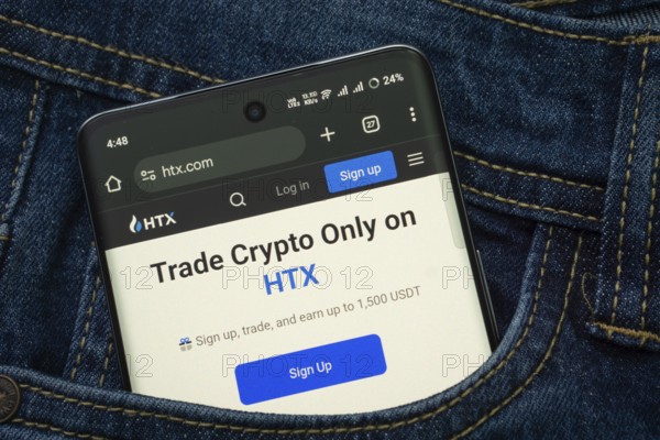 Dhaka, Bangladesh- 15 June 2025: A smartphone displaying the HTX web interface peeks out of a denim