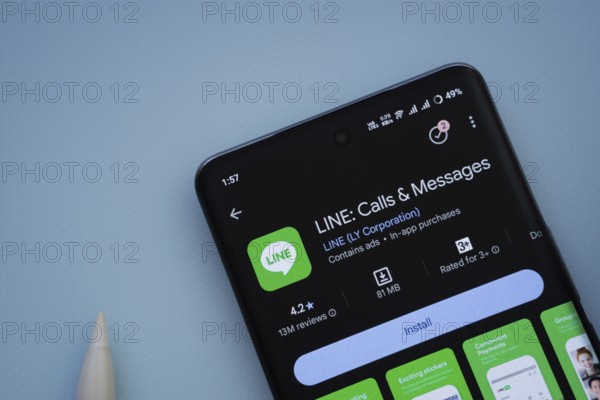 Dhaka, Bangladesh- 29 May 2025: On a blue surface, a smartphone displays the LINE app within the