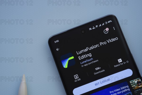 Dhaka, Bangladesh- 29 May 2025: On a blue surface, a smartphone displays the LumaFusion app within