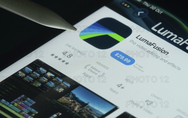 Dhaka, Bangladesh- 30 Oct 2025: LumaFusion app on a iPad screen with a pen pointing at the install