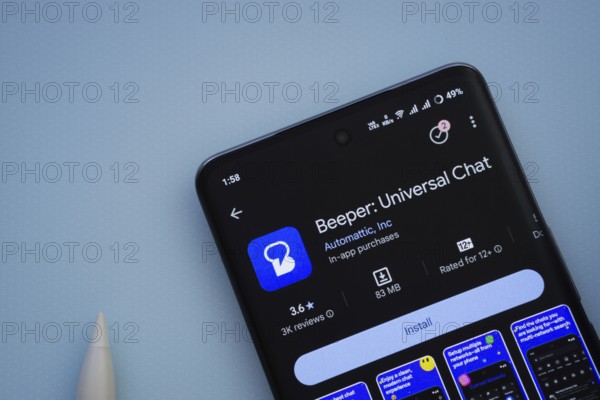 Dhaka, Bangladesh- 29 May 2025: On a blue surface, a smartphone displays the Beeper app within the