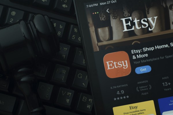 Dhaka, Bangladesh- 28 Oct 2025: An iPad displaying the Etsy app against a judge's gavel and dark
