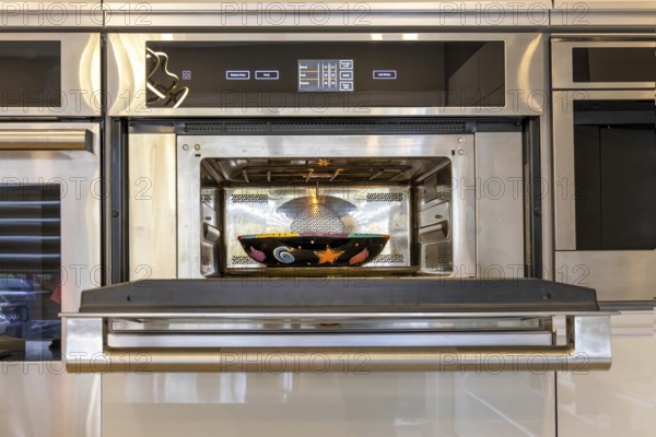 Modern kitchenware and microwave in luxury designer kitchen. Food preparation with expensive