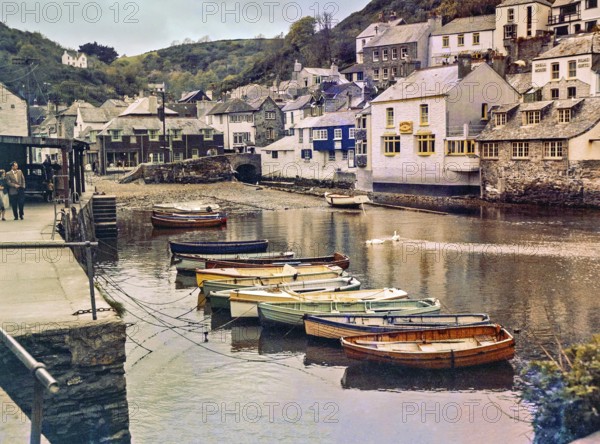 Historic waterfront buildings around the harbour river mouth of the River Pol at village of