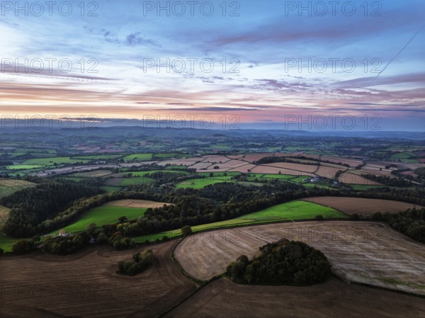 Sunset of Devon Farms and Fields over Berry Pomeroy from a drone, Totnes, England, United Kingdom