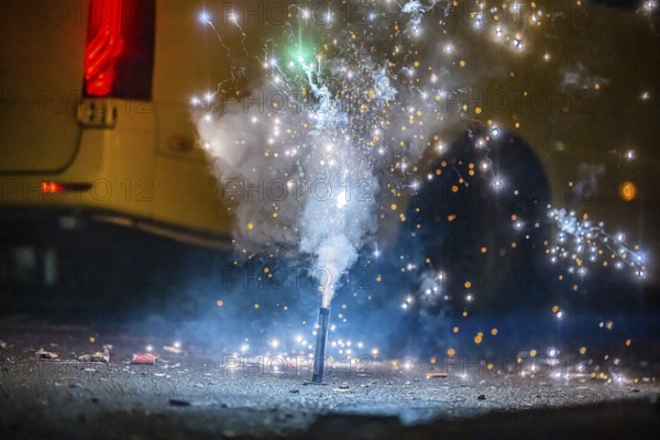 Burnt off fireworks are lying on the street, firecracker smoke produces smoke. New Year's night on