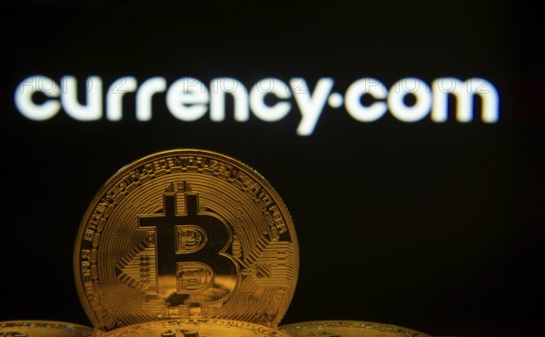 Dhaka, Bangladesh- 22 June 2025: Close-up of Bitcoin coins with the Currency.com logo visible on a