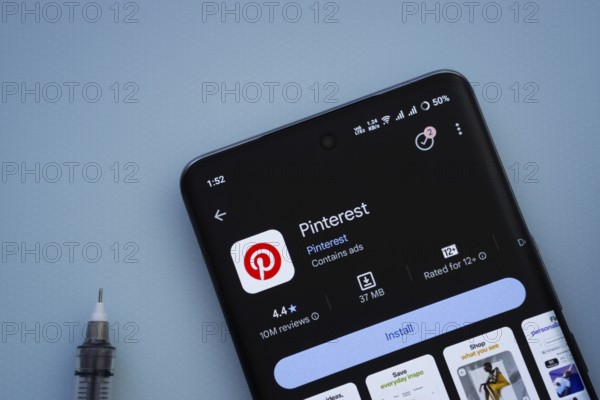 Dhaka, Bangladesh- 29 May 2025: On a blue surface, a smartphone displays the Pinterest app within