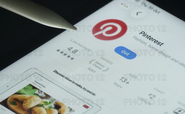 Dhaka, Bangladesh- 30 Oct 2025: Pinterest app on a iPad screen with a pen pointing at the install