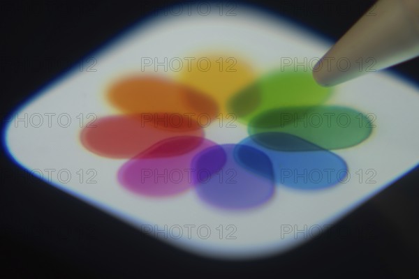Dhaka, Bangladesh- 06 Dec 2025: Close-up of the Apple Photos app on a screen with a stylus pointing
