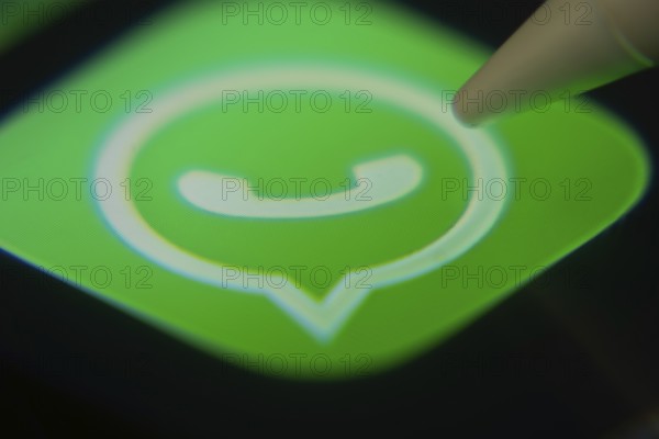 Dhaka, Bangladesh- 06 Dec 2025: Close-up of the WhatsApp app on a screen with a stylus pointing at