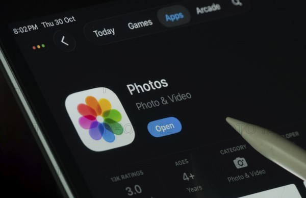 Dhaka, Bangladesh- 30 Oct 2025: Apple Photos app displayed on a iPad screen in dark mode with a