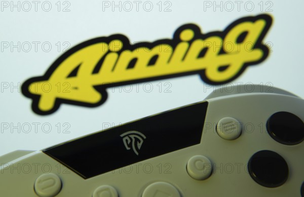 Dhaka, Bangladesh- 24 Mar 2025: A close-up of a gamepad with the Aiming Inc seen on screen in the