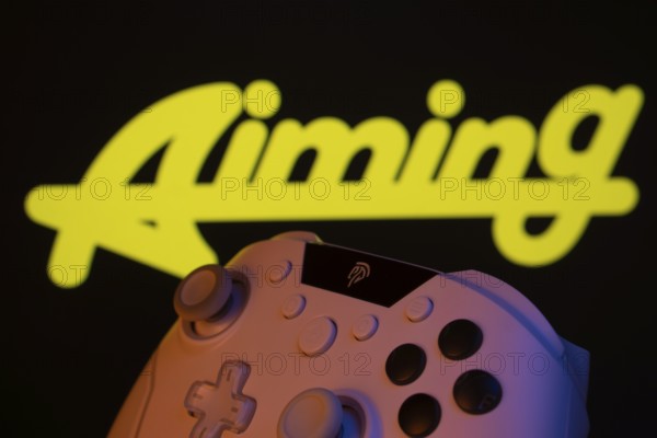 Dhaka, Bangladesh- 20 Mar 2025: A close-up of a gamepad with the Aiming Inc seen on screen in the