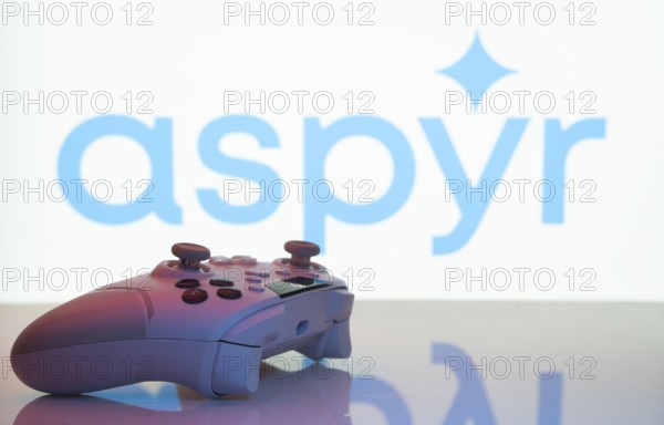 Dhaka, Bangladesh- 20 Mar 2025: A close-up of a white gamepad with the Aspyr seen on screen in the