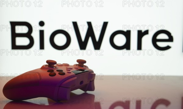 Dhaka, Bangladesh- 20 Mar 2025: A close-up of a white gamepad with the BioWare seen on screen in