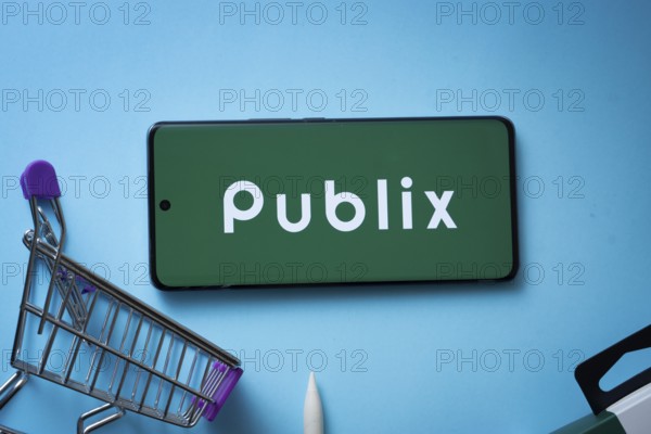 Dhaka, Bangladesh- 03 July 2025: Smartphone displaying Publix logo with shopping cart on a blue