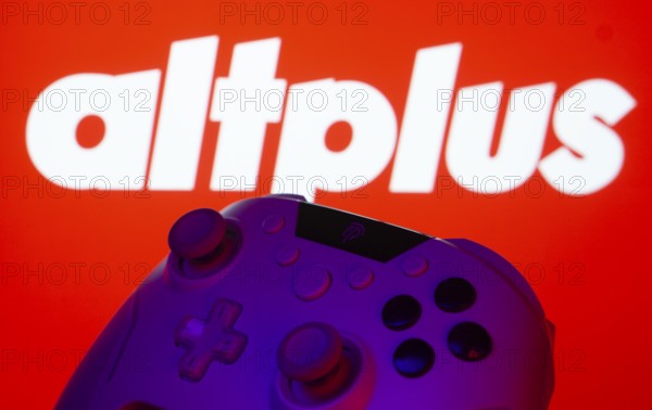 Dhaka, Bangladesh- 20 Mar 2025: A close-up of a gamepad with the AltPlus Inc seen on screen in the