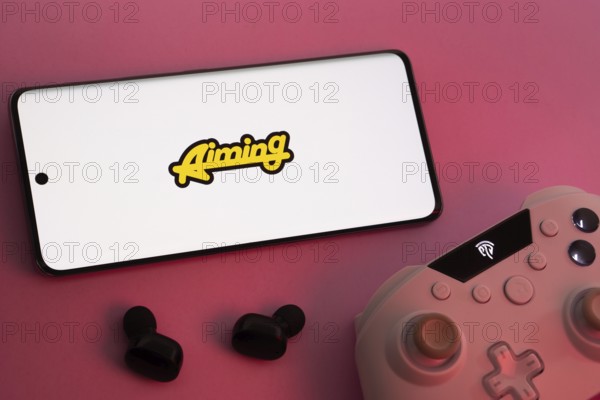 Dhaka, Bangladesh- 08 Apr 2025: A smartphone displaying the Aiming Inc logo next to a gaming