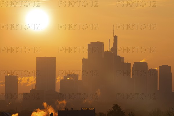 The sun rises behind Frankfurt's banking skyline, Frankfurt am Main, Hesse, Germany