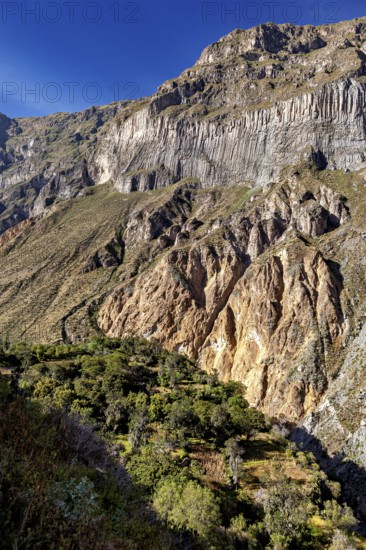 Large, steep rock walls with natural geological patterns, The landscape of the Colca Canyon in the