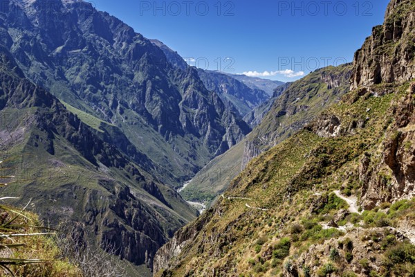 High mountains with deep gorges and rugged cliffs under a blue sky, the landscape of Colca Canyon