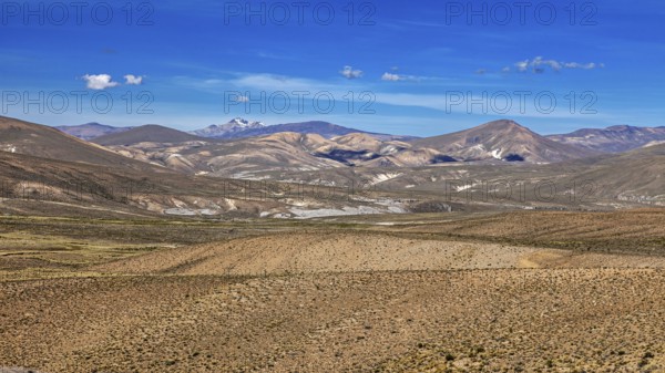 Pristine vast landscape with rolling desert under blue sky, The Andean highlands of Peru